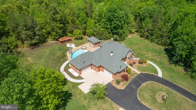 an aerial view of a house with garden space and street view