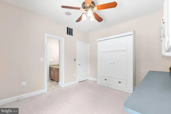 a living room with furniture a flat screen tv and a window