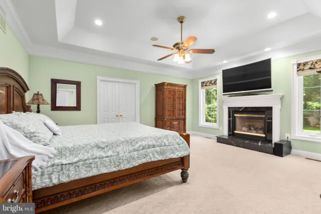 a view of a swimming pool with a lounge chair and trees in the background