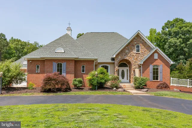 an aerial view of a house with a swimming pool
