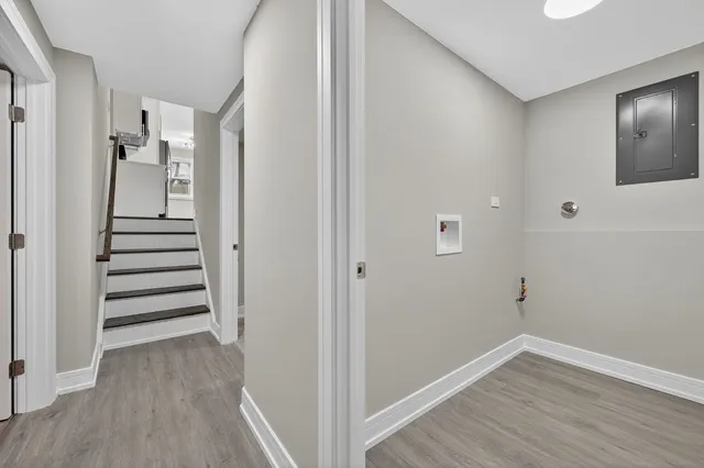 a view of a hallway with wooden floor and entryway