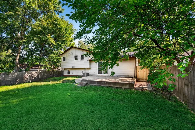 a front view of a house with a garden and yard
