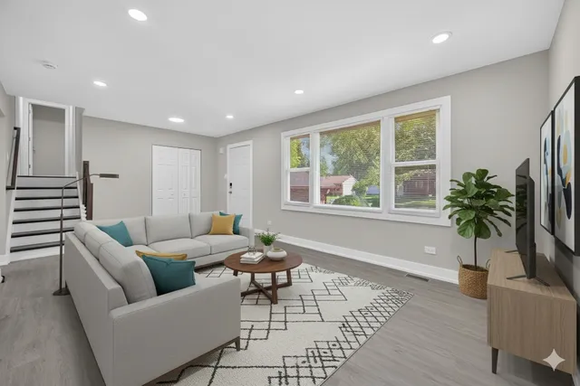 a living room with furniture and a potted plant