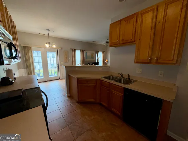 a kitchen with stainless steel appliances granite countertop a sink stove and cabinets