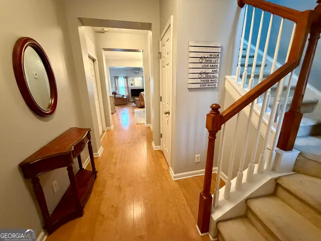 a view of an entryway with wooden floor