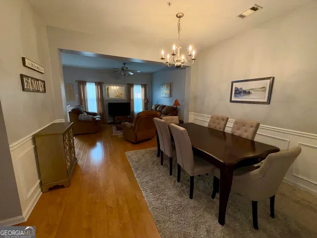 a view of a dining room with furniture and chandelier