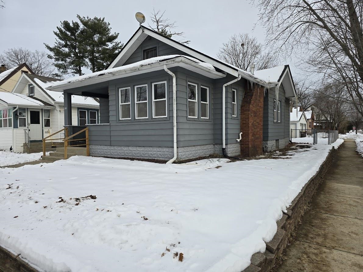 2103 North Court Street Rockford, IL 61103 - Photo 13 of 14 a front view of a house with a yard covered in snow