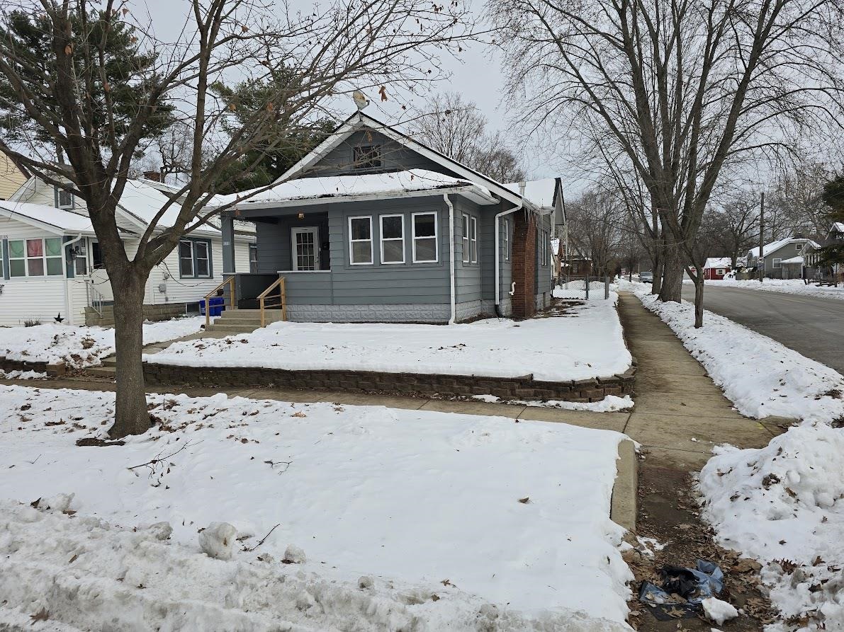 2103 North Court Street Rockford, IL 61103 - Photo 14 of 14 a front view of a house with a yard covered with snow in front of house