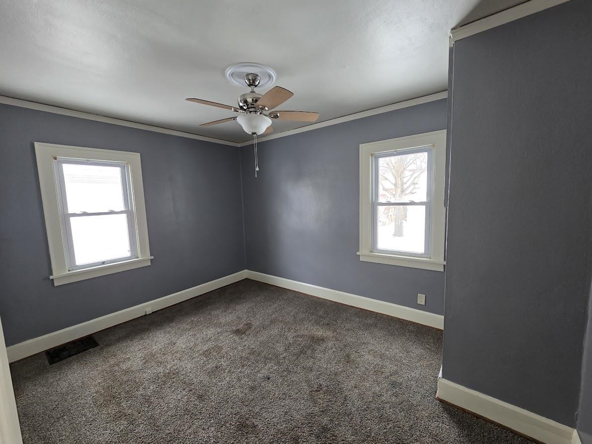 2103 North Court Street Rockford, IL 61103 - Photo 9 of 14 an empty room with a window and a fan