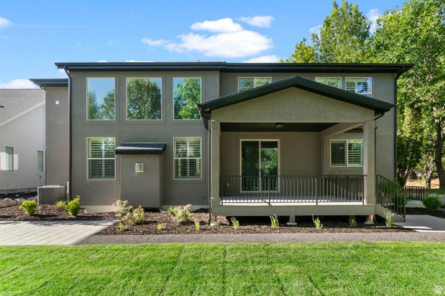 2724 Mt Jordan Road Sandy, UT 84092 - Photo 32 of 39 Rear exterior featuring a covered porch with a sliding glass door, black railing, and stairs to grade