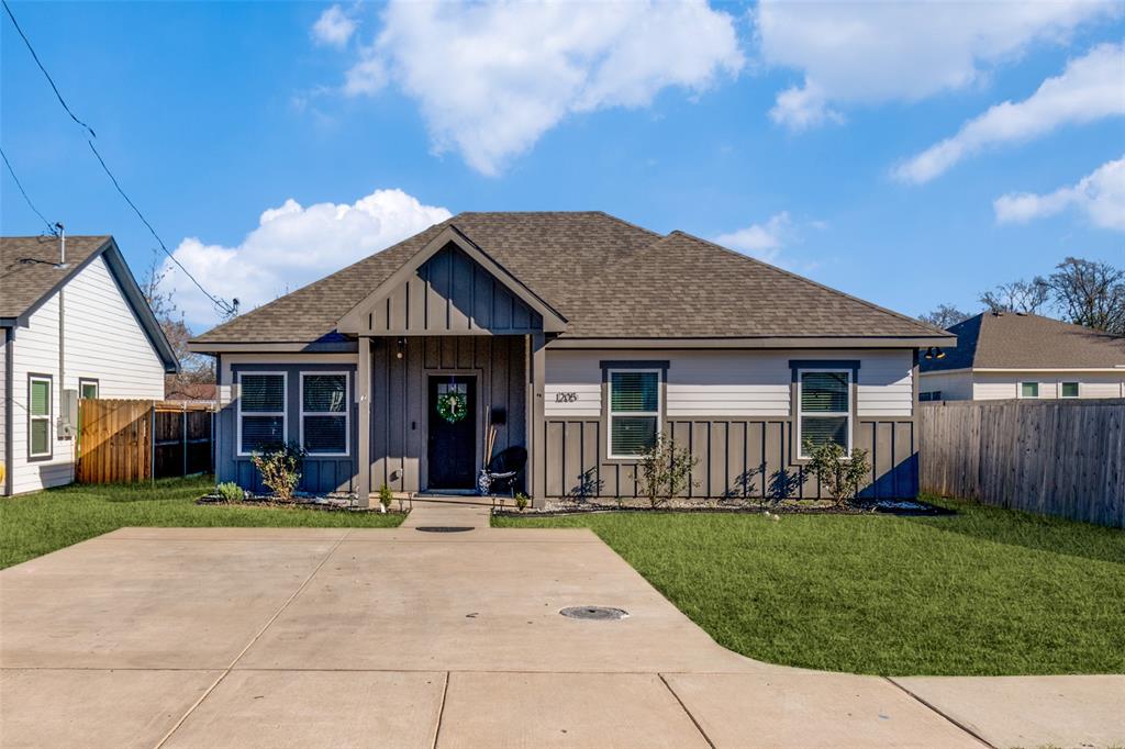 a front view of a house with a garden and plants