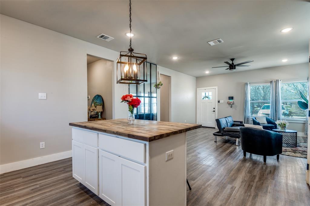 1205 Edgar Street Greenville, TX 75401 - Photo 12 of 26 a view of a kitchen and dining room with wooden floor