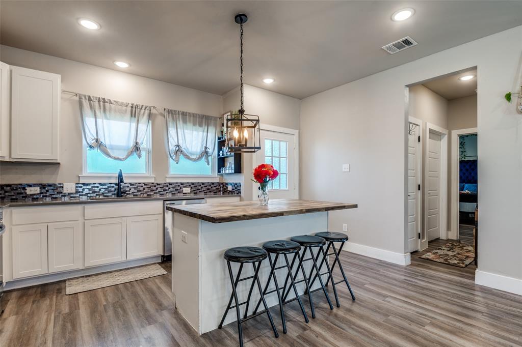 1205 Edgar Street Greenville, TX 75401 - Photo 13 of 26 a kitchen with stainless steel appliances granite countertop wooden floors and sink
