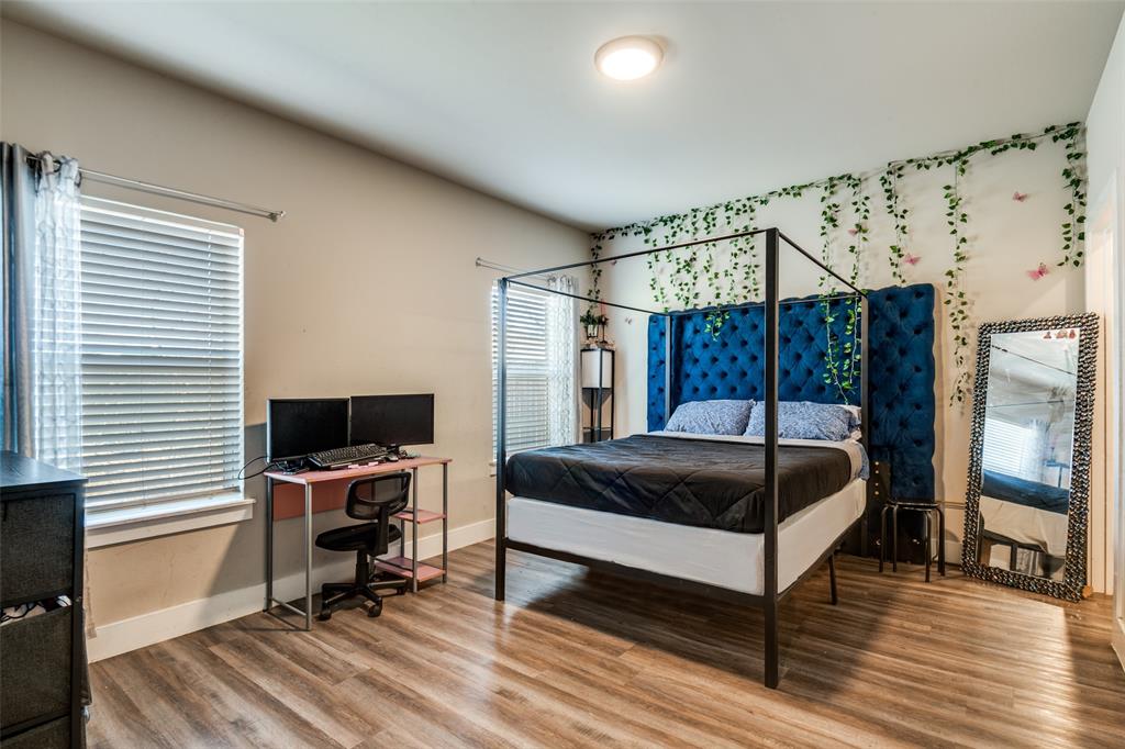 1205 Edgar Street Greenville, TX 75401 - Photo 15 of 26 a bedroom with a bed a desk and chair