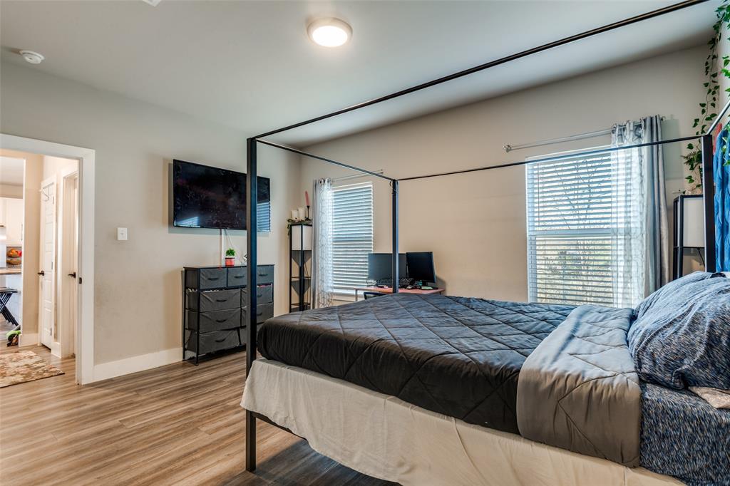 1205 Edgar Street Greenville, TX 75401 - Photo 18 of 26 a living room with a bed furniture and a flat screen tv