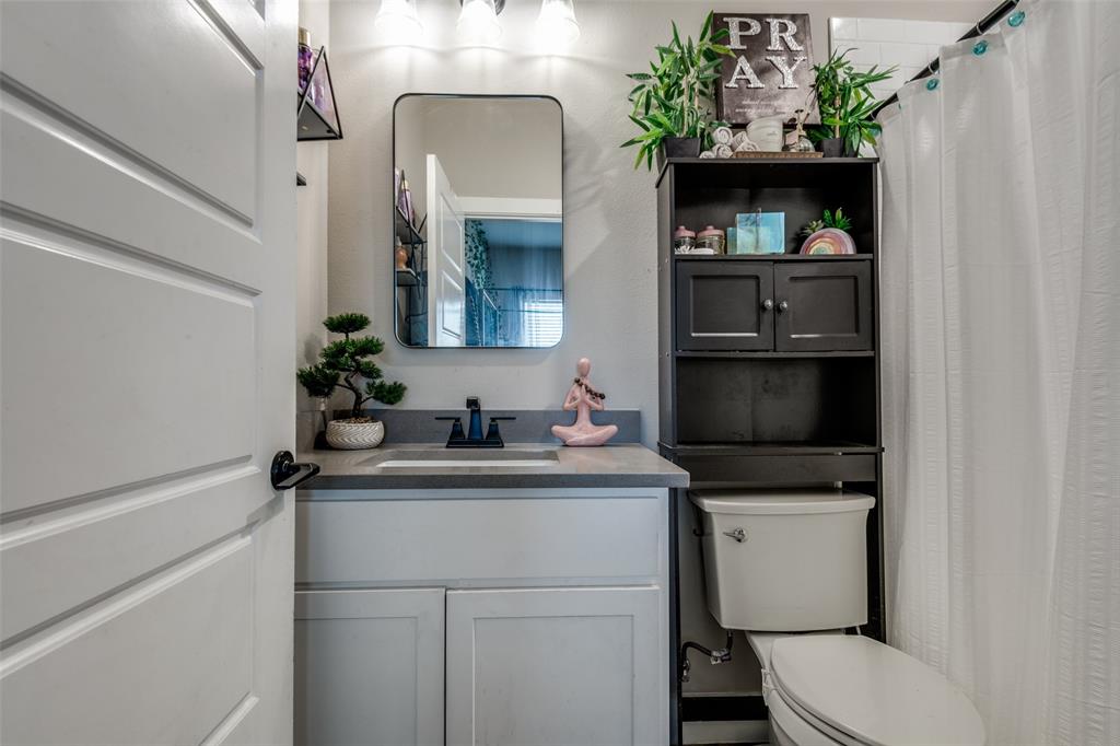 1205 Edgar Street Greenville, TX 75401 - Photo 21 of 26 a bathroom with a toilet sink and mirror