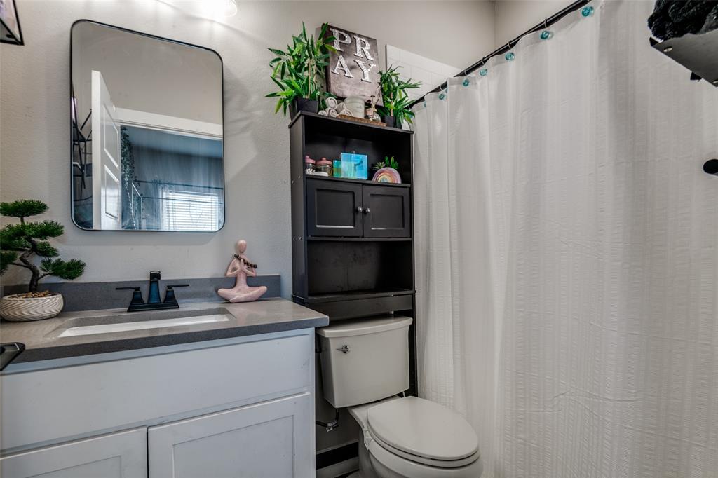 1205 Edgar Street Greenville, TX 75401 - Photo 22 of 26 a bathroom with a sink toilet and shower