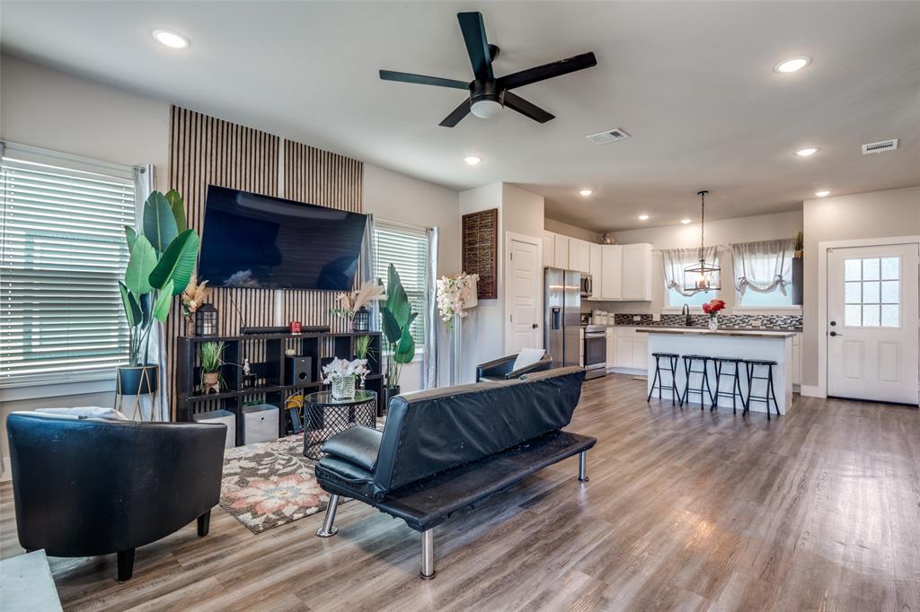 1205 Edgar Street Greenville, TX 75401 - Photo 8 of 26 a living room with fireplace furniture and a flat screen tv