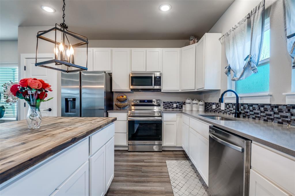 1205 Edgar Street Greenville, TX 75401 - Photo 10 of 26 a kitchen with stainless steel appliances granite countertop a sink stove and refrigerator