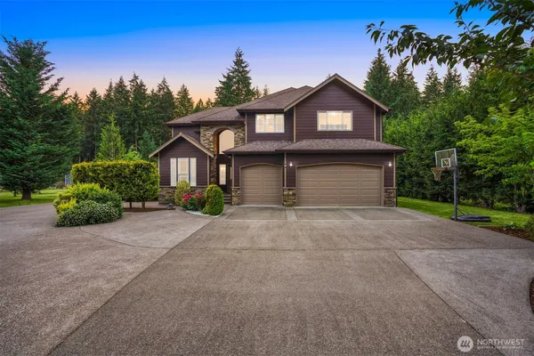 a front view of a house with a yard and garage
