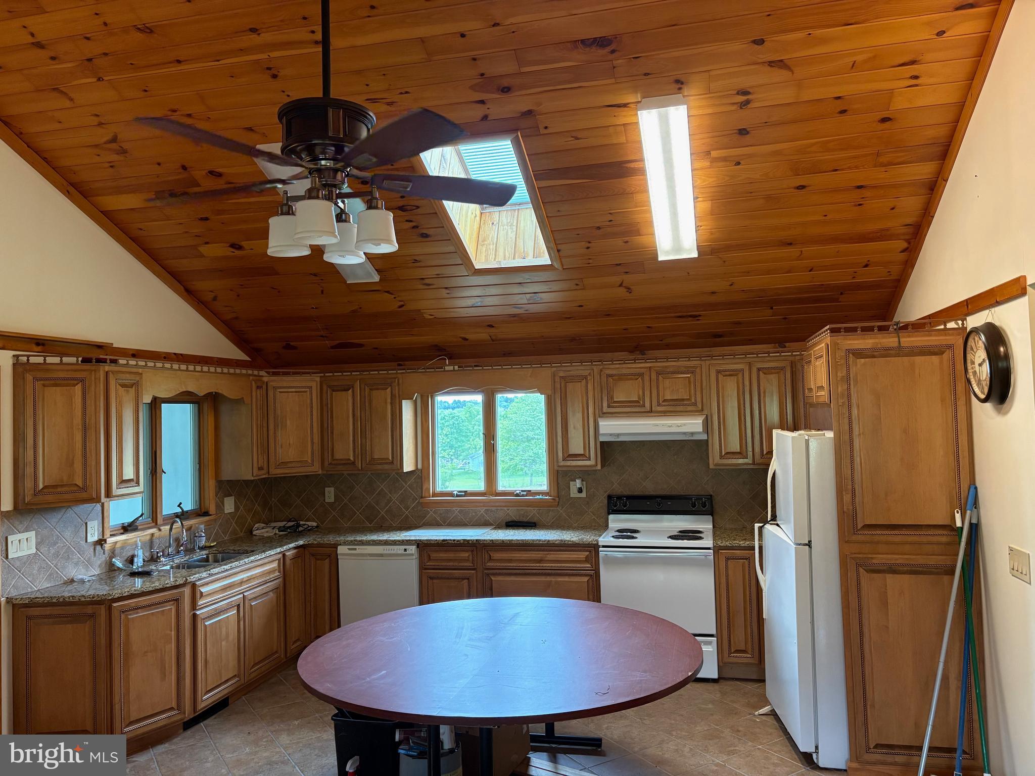 4319 Viola Pike Ramey, PA 16671 - Photo 2 of 23 a kitchen with stainless steel appliances a table chairs and refrigerator