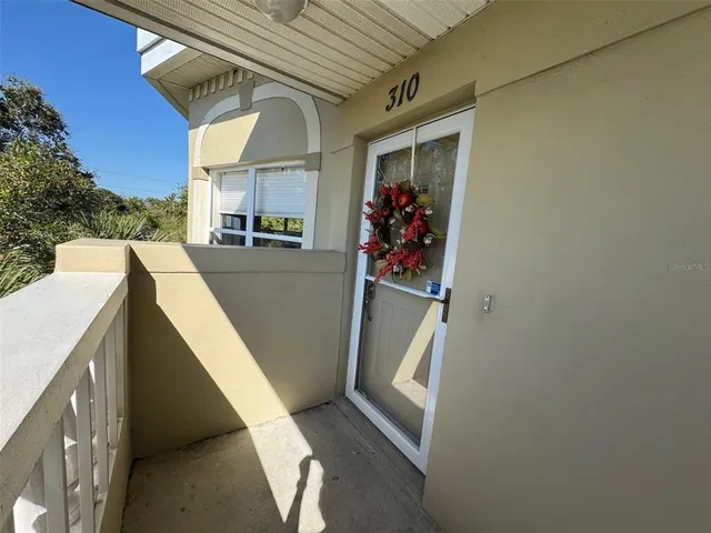 an aerial view of a house with a lake view