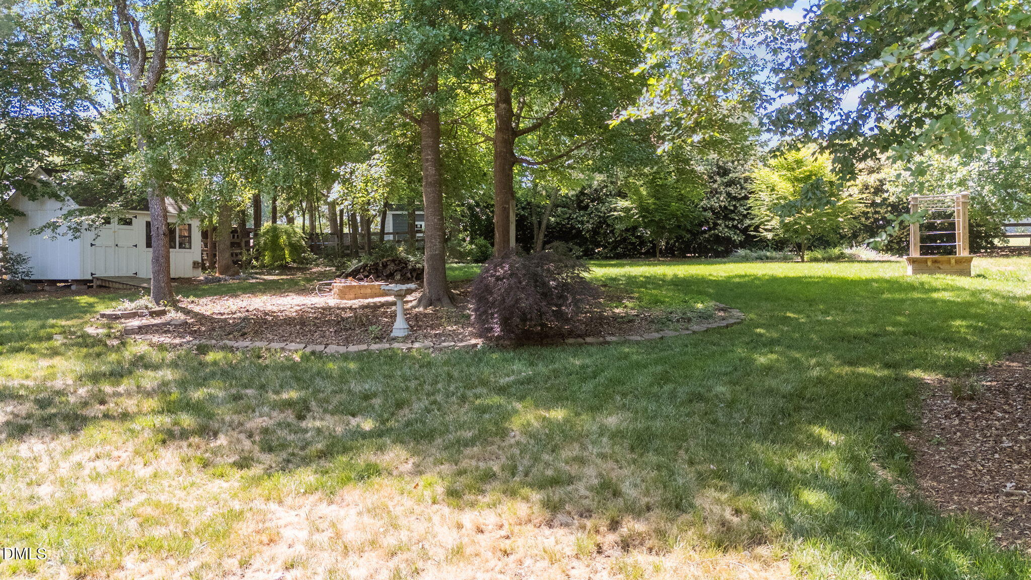 6820 Oviedo Drive Raleigh, NC 27603 - Photo 38 of 50 a backyard of a house with lots of green space