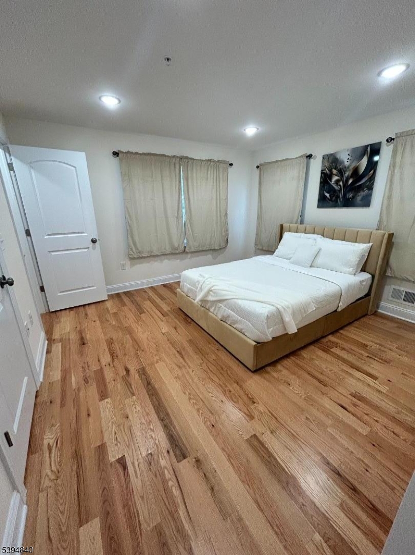 337 13th Avenue, Unit 1 Newark, NJ 07103 - Photo 11 of 14 a spacious bedroom with a bed and a dresser