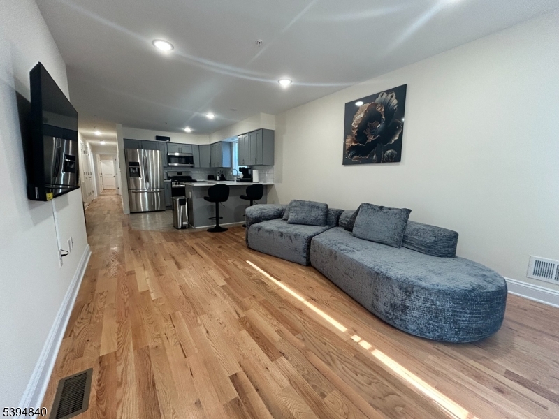 337 13th Avenue, Unit 1 Newark, NJ 07103 - Photo 2 of 14 a living room with furniture and a flat screen tv
