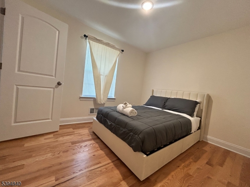 337 13th Avenue, Unit 1 Newark, NJ 07103 - Photo 5 of 14 a bedroom with a bed and a window