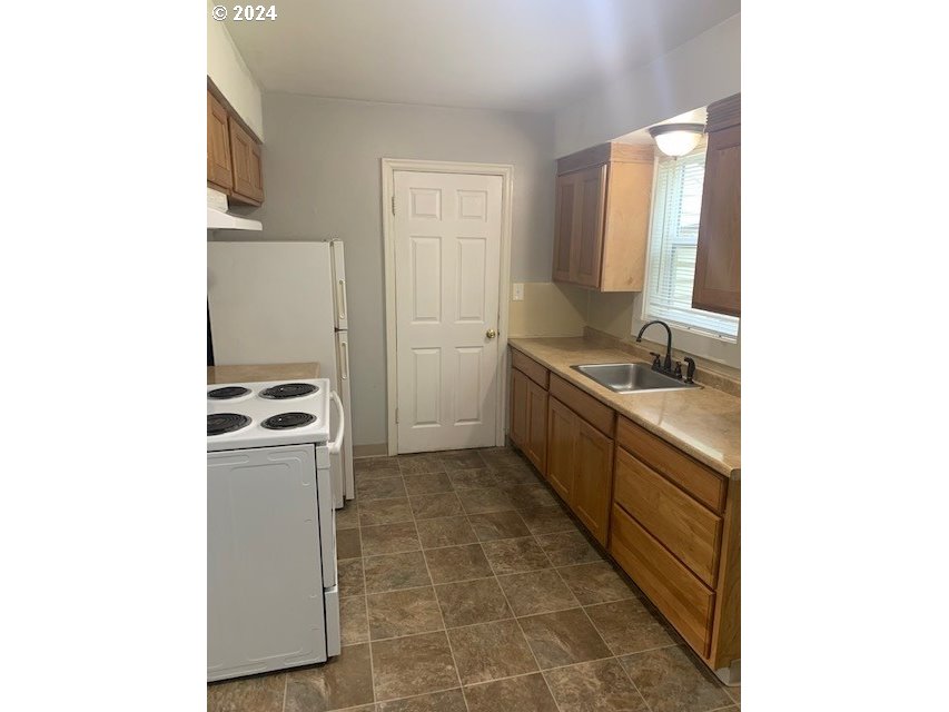 8445 Southeast Washington Street Portland, OR 97216 - Photo 12 of 17 a kitchen with a sink and cabinets