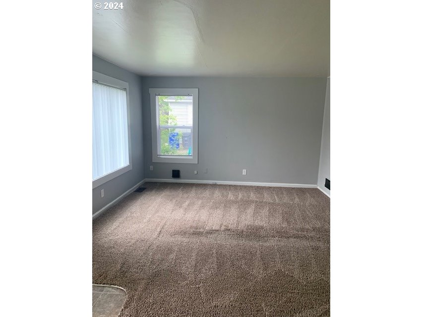 8445 Southeast Washington Street Portland, OR 97216 - Photo 7 of 17 a view of an empty room with a window
