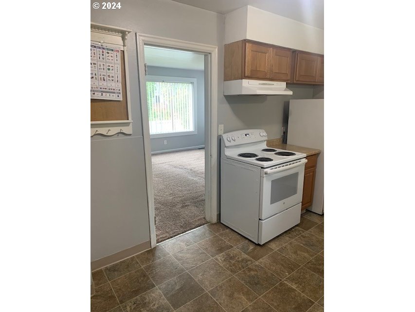 8445 Southeast Washington Street Portland, OR 97216 - Photo 10 of 17 a kitchen with a stove