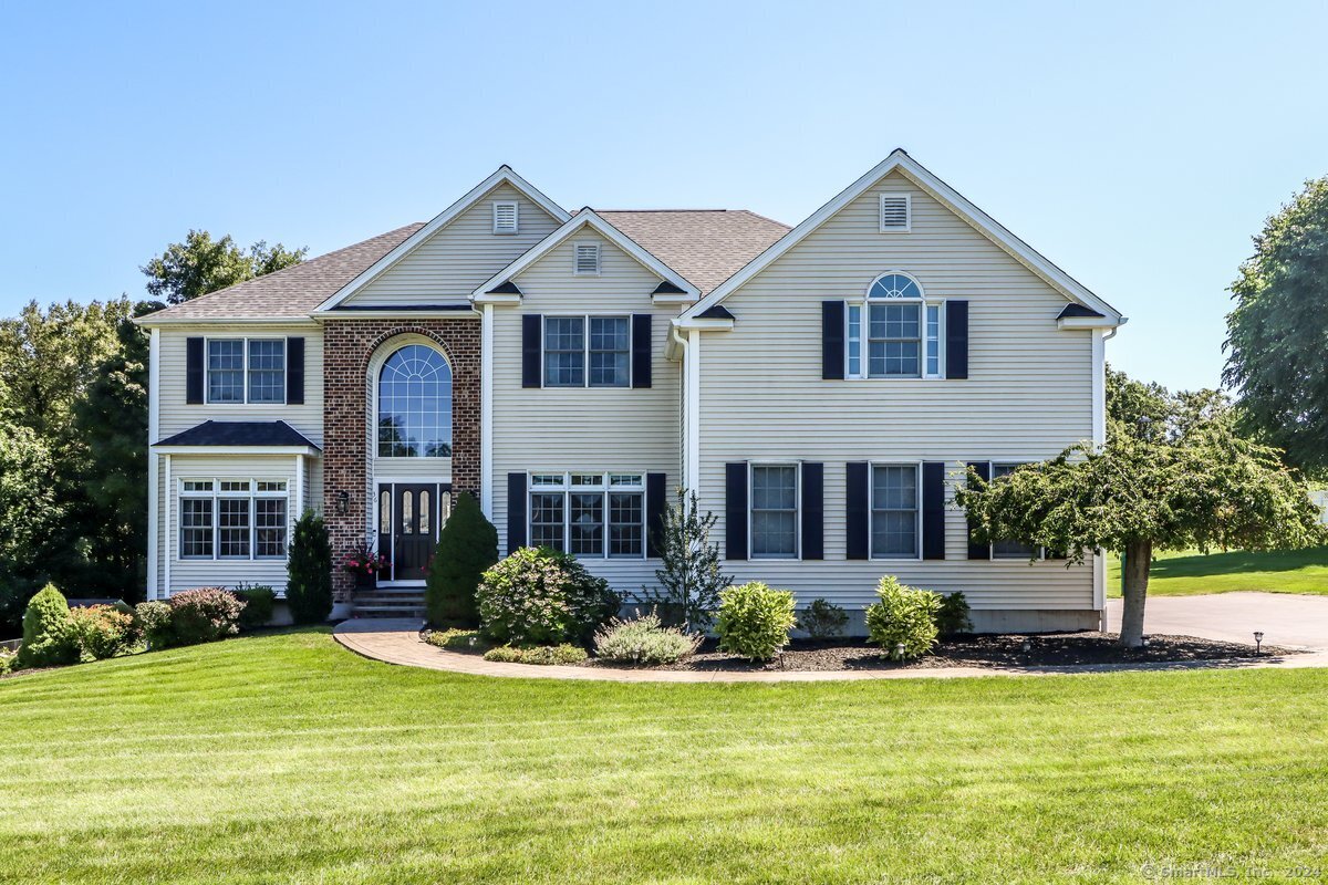 a front view of a house with a yard