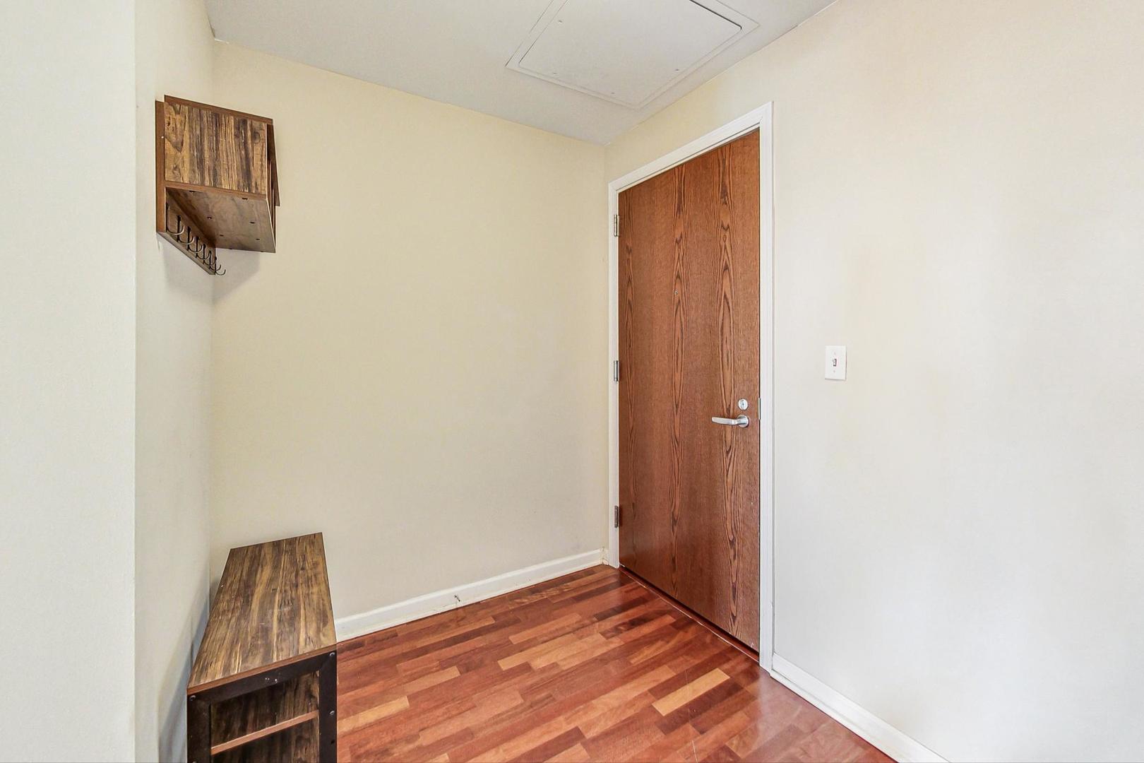 1255 South State Street, Unit 1918 Chicago, IL 60605 - Photo 2 of 16 a view of an empty room with wooden floor and a window