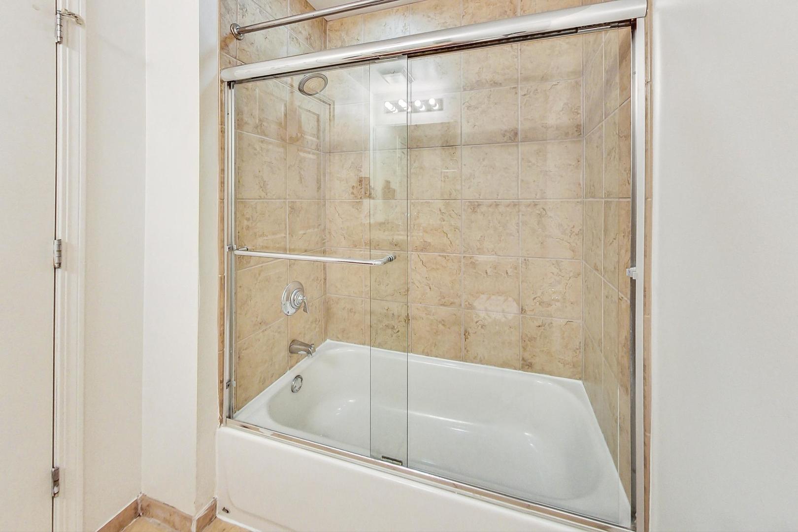 1255 South State Street, Unit 1918 Chicago, IL 60605 - Photo 13 of 16 a bathroom with a bathtub