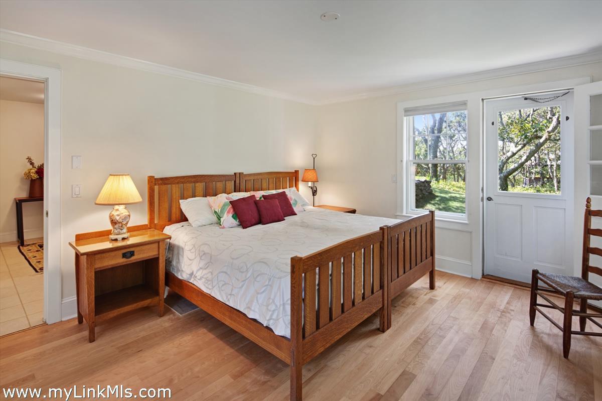 78 Hammett Road Chilmark, MA 02535 - Photo 42 of 53 a bedroom with a bed and a table in it
