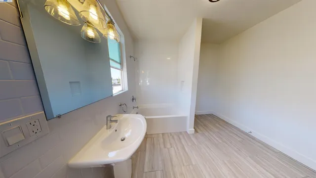 a bathroom with a bathtub a sink and a mirror