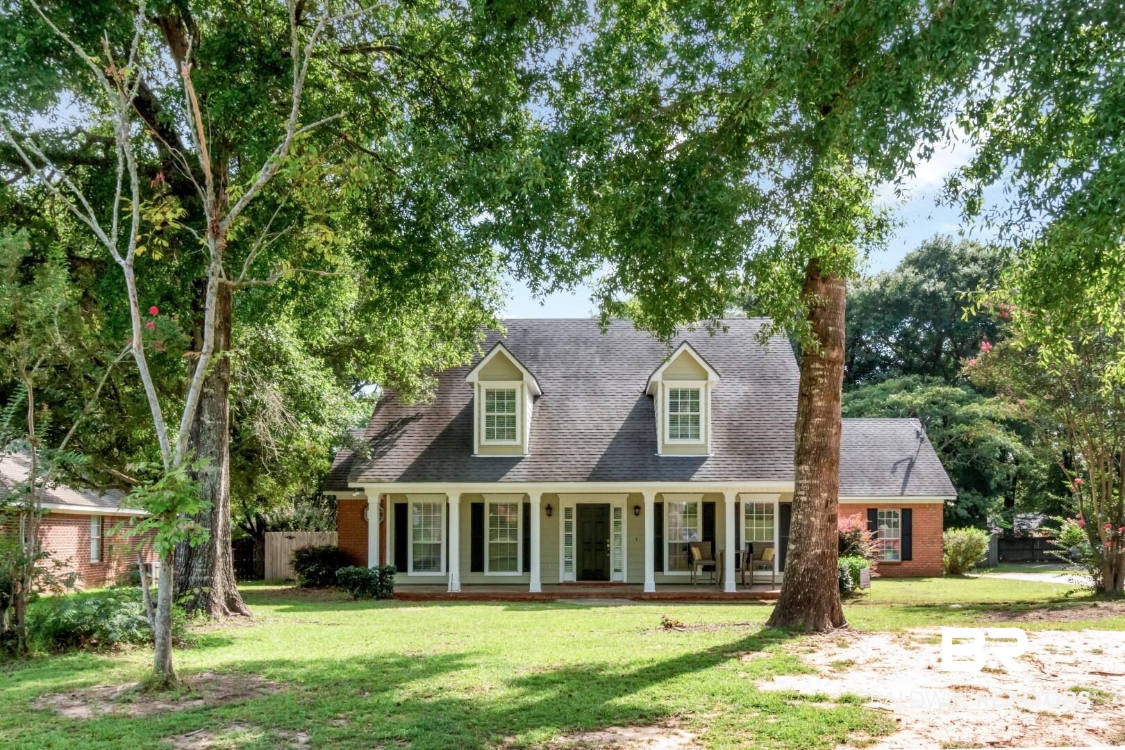 9991 Wedgefield Court Mobile, AL 36608 - Photo 1 of 30 View of front of home with covered porch and a front yard