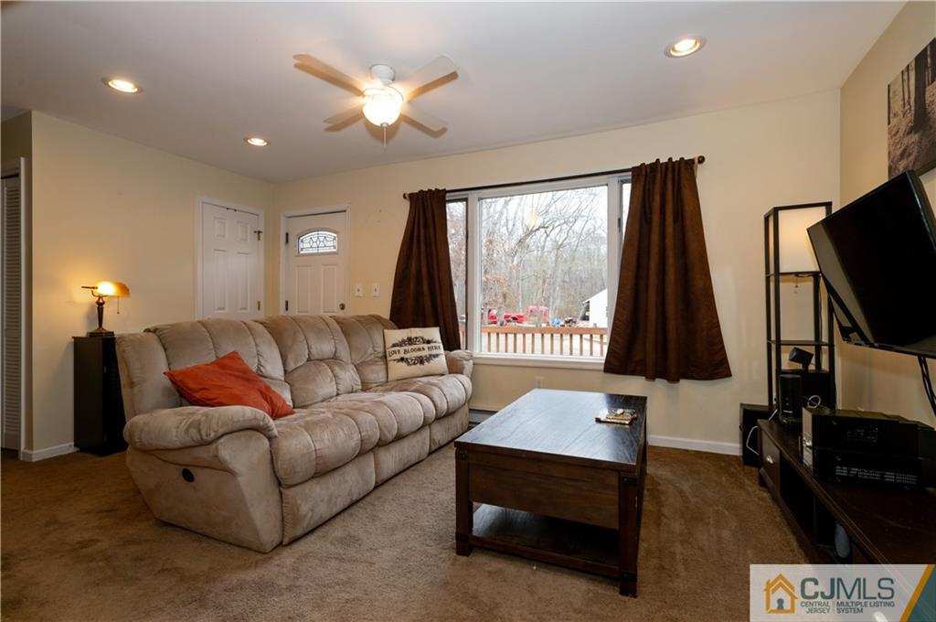 10 Soden Lane Old Bridge, NJ 08857 - Photo 2 of 20 a living room with furniture a flat screen tv and a fireplace