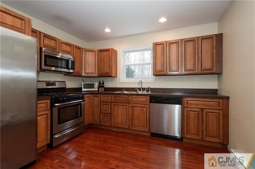 10 Soden Lane Old Bridge, NJ 08857 - Photo 7 of 20 a kitchen with stainless steel appliances granite countertop a stove a sink and a microwave