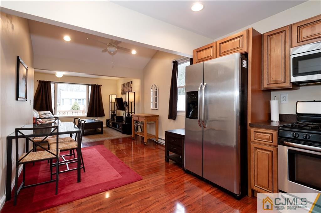 10 Soden Lane Old Bridge, NJ 08857 - Photo 8 of 20 a kitchen with stainless steel appliances granite countertop a refrigerator stove top oven dining table and chairs