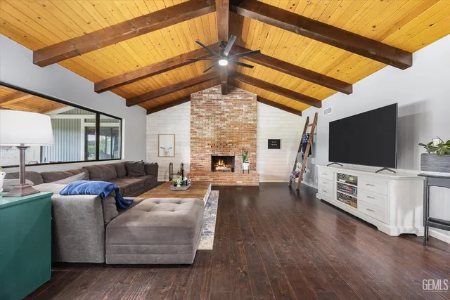 a spacious bedroom with a bed and a chandelier