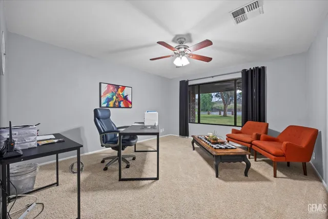a spacious bedroom with a bed and a chandelier