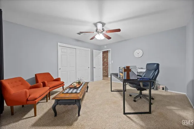 a spacious bedroom with a bed and a chandelier