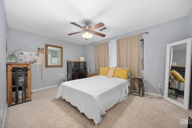 a living room with a large window and furniture