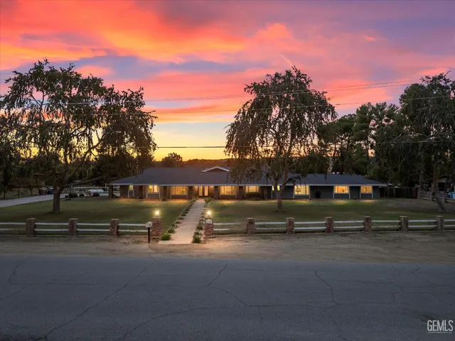 a view of a swimming pool with lake and houses in the back