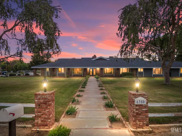a view of a swimming pool with a yard and a fountain
