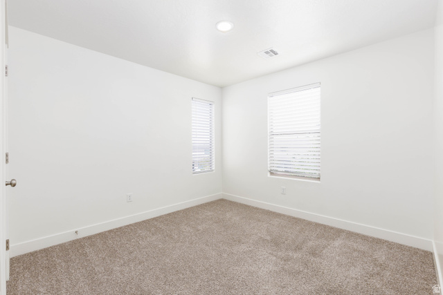 3157 Deseret Drive St. George, UT 84790 - Photo 19 of 24 Carpeted room featuring two windows with horizontal blinds, white walls, and a recessed ceiling light