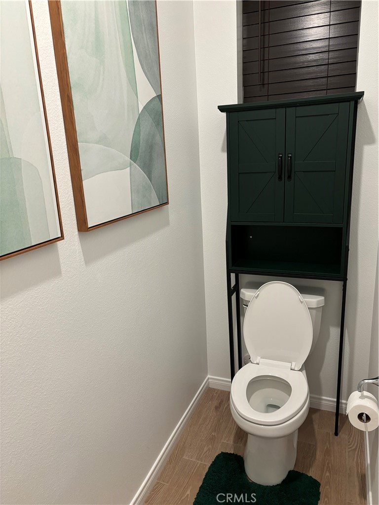 1375 Yeager Avenue Rialto, CA 92376 - Photo 6 of 12 a white toilet sitting next to a small sink